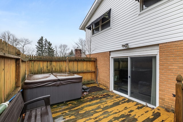 wooden deck with a hot tub