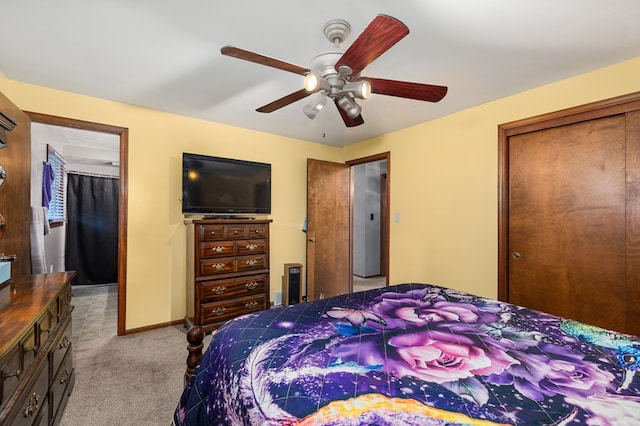 carpeted bedroom with ceiling fan and a closet