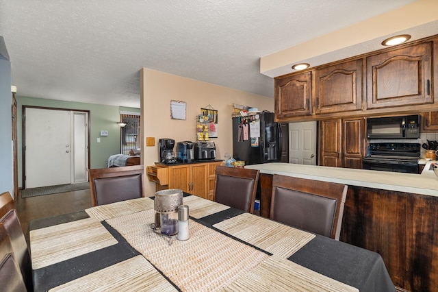 dining room featuring hardwood / wood-style floors and a textured ceiling