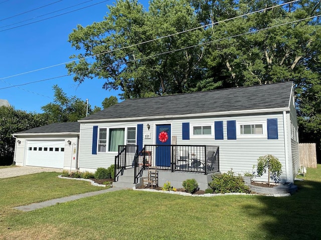 227 S Jefferson St, Loudonville, OH 44842 - view of front of house with dirt driveway, a front yard, a shingled roof, and an attached garage