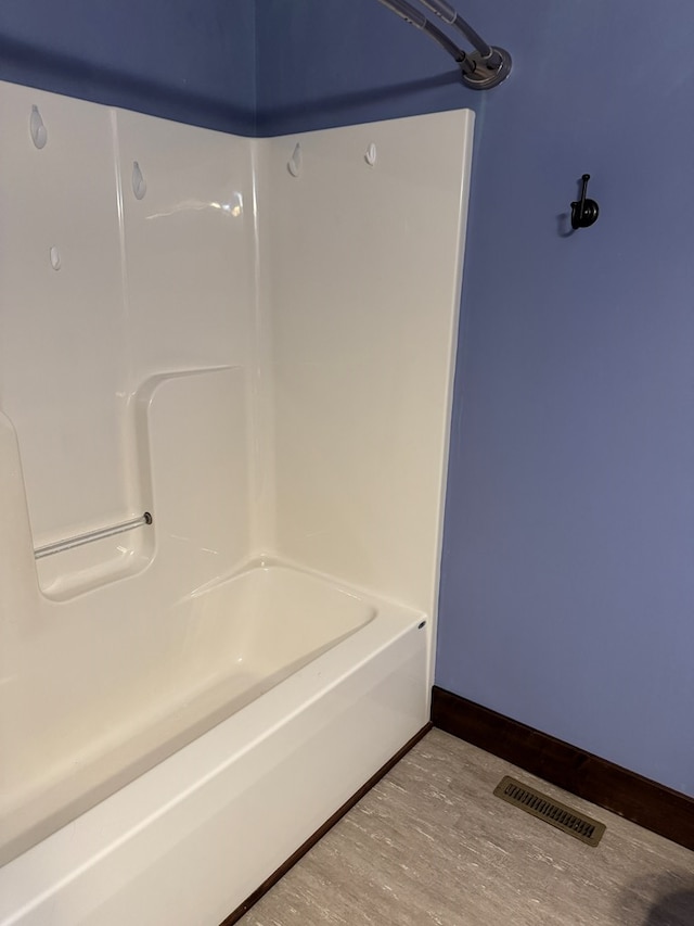 227 S Jefferson St, Loudonville, OH 44842 - bathroom with wood finished floors and shower / bath combination