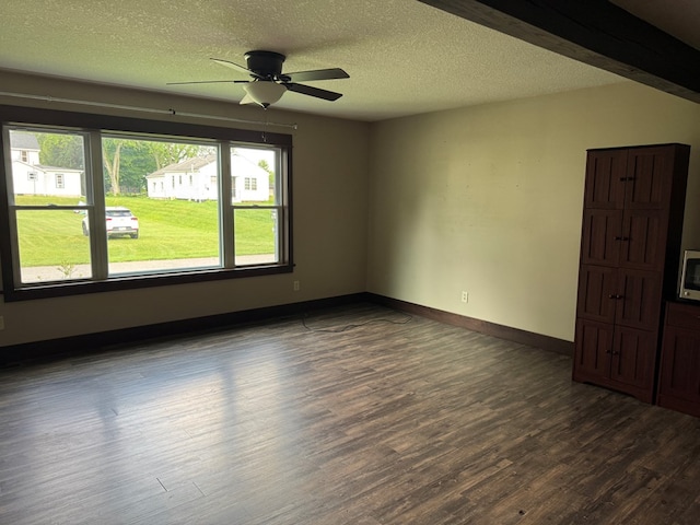 227 S Jefferson St, Loudonville, OH 44842 - empty room featuring plenty of natural light, dark wood finished floors, a ceiling fan, and a textured ceiling