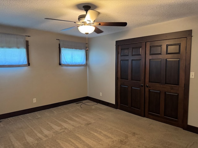 227 S Jefferson St, Loudonville, OH 44842 - unfurnished bedroom with light carpet, a textured ceiling, and a ceiling fan