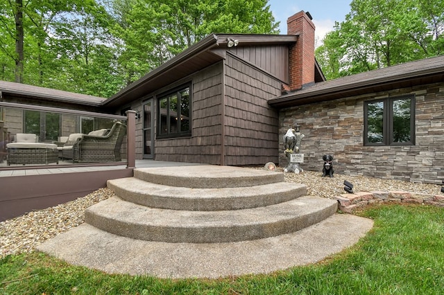 58 Edgewood Dr, Perrysville, OH 44864 - view of exterior entry featuring a chimney and stone siding