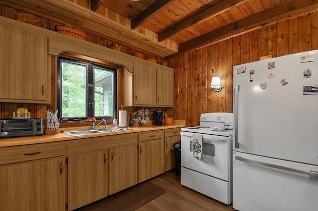 58 Edgewood Dr, Perrysville, OH 44864 - kitchen featuring white appliances, a sink, wood ceiling with exposed beams, light countertops, and wooden walls