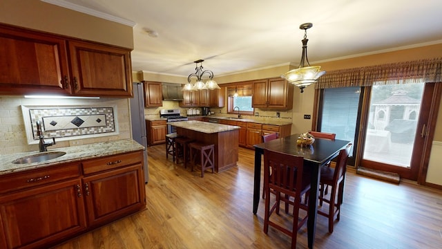 dining space featuring crown molding and wood finished floors