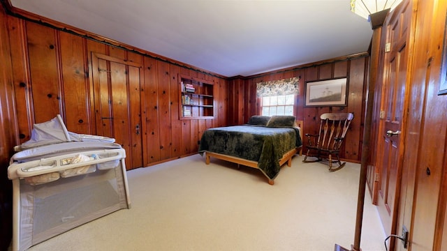 carpeted bedroom featuring wooden walls