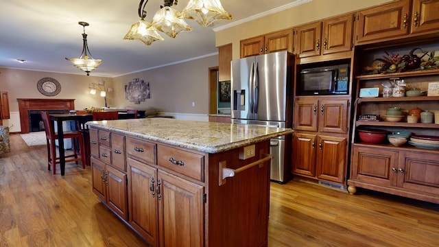 kitchen featuring an inviting chandelier, stainless steel refrigerator with ice dispenser, crown molding, light wood-type flooring, and black microwave