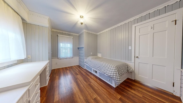 unfurnished bedroom with crown molding and dark wood finished floors