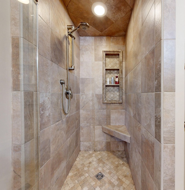 bathroom with a tile shower
