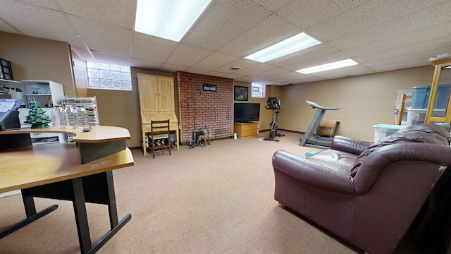 carpeted living area with a drop ceiling