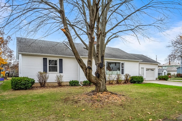 view of front of property featuring a garage and a front lawn