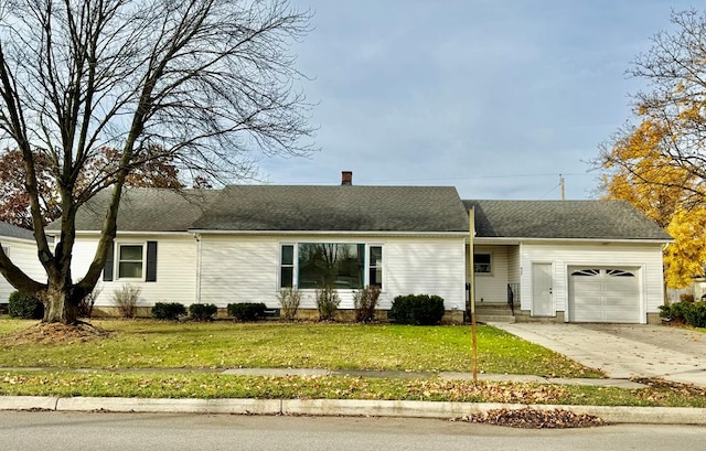 ranch-style home featuring a garage and a front lawn