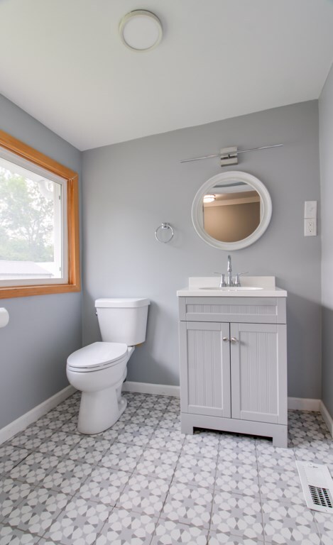 821 Charles St, Galion, OH 44833 - bathroom with vanity, toilet, baseboards, and tile patterned floors