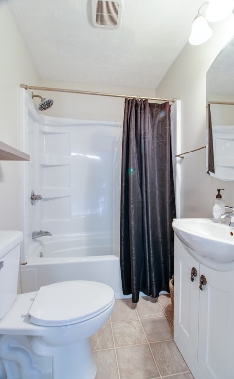 821 Charles St, Galion, OH 44833 - full bath with toilet, vanity, shower / bath combination with curtain, and tile patterned floors