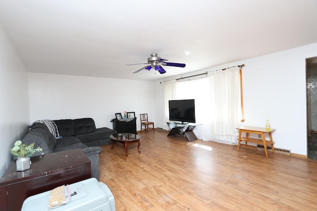 living room with baseboards, ceiling fan, light wood-style flooring, and a baseboard radiator