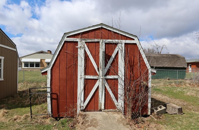 view of outbuilding with an outdoor structure and fence