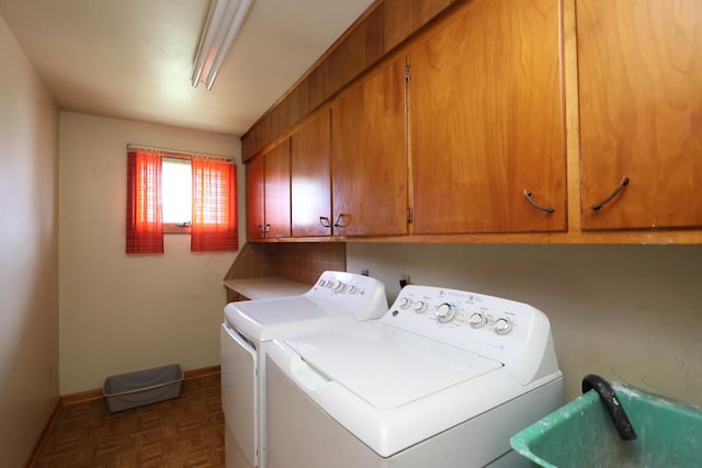 clothes washing area with washing machine and clothes dryer, a sink, cabinet space, and baseboards
