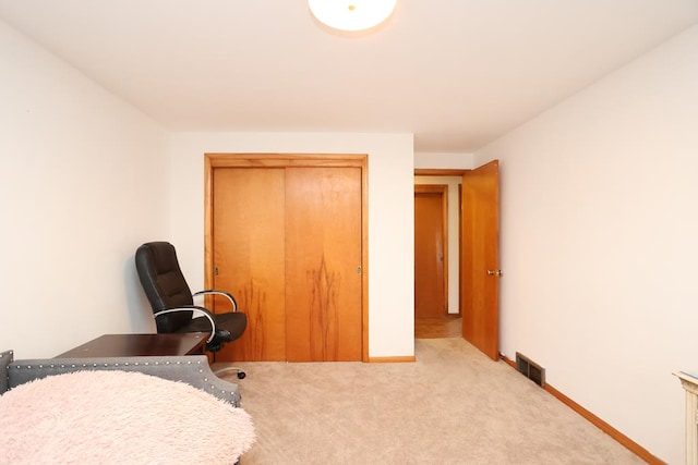 carpeted home office with baseboards and visible vents