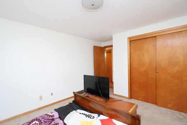 bedroom featuring baseboards, a closet, and carpet floors