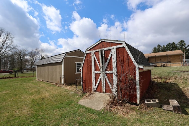 view of outbuilding featuring an outbuilding and fence