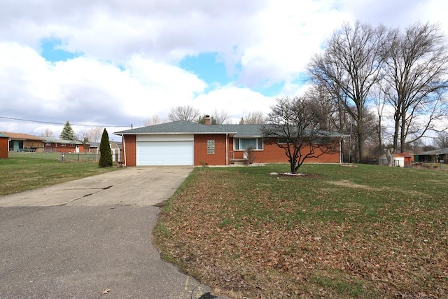 ranch-style house featuring driveway, a front yard, a chimney, an attached garage, and brick siding