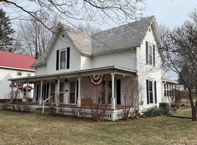 view of front of home with a porch, central AC unit, and a front lawn