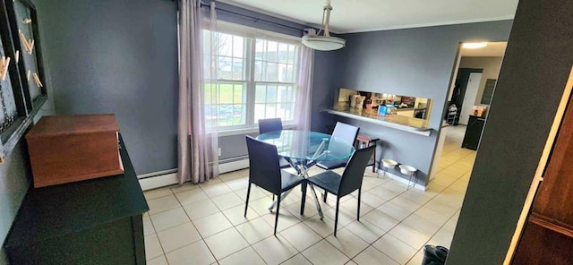 dining room with light tile patterned floors, crown molding, and a baseboard radiator