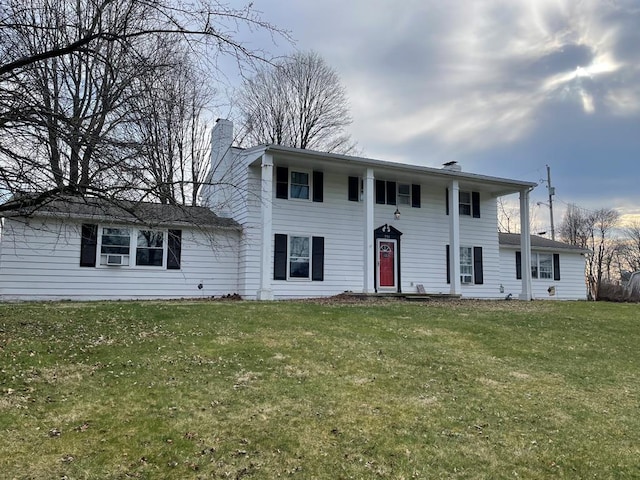 view of front facade featuring a front yard and a chimney