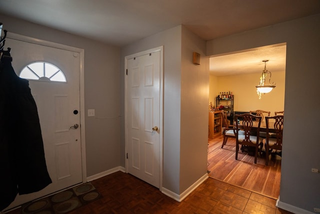 foyer featuring baseboards
