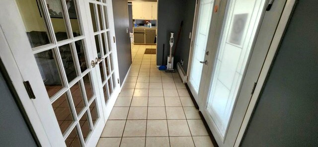 hall with light tile patterned floors and french doors