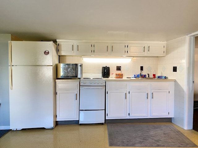 kitchen with white cabinets, decorative backsplash, white refrigerator, and range