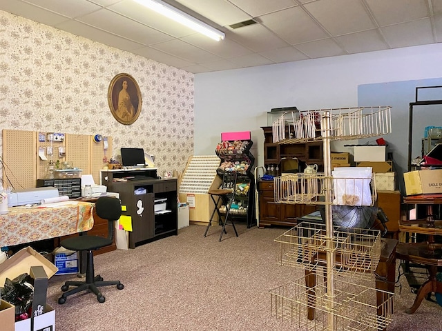 carpeted home office with a paneled ceiling