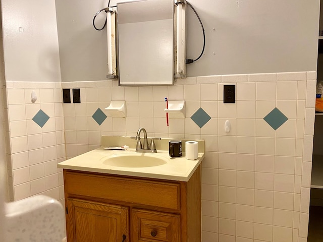 bathroom featuring vanity and tile walls