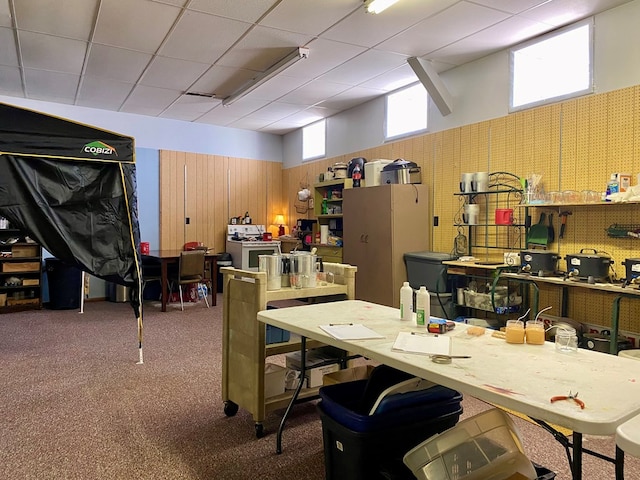 interior space with a workshop area, wooden walls, and carpet