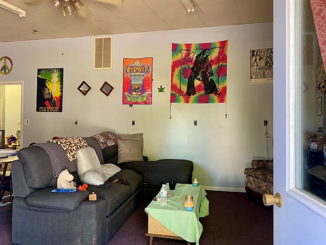 carpeted living room with ceiling fan