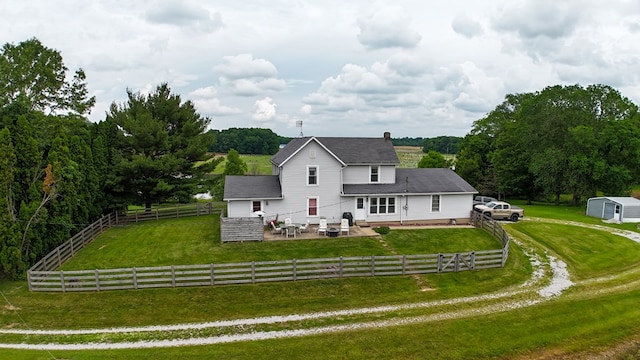 5837 Township Road 103, Mount Gilead, OH 43338 - back of house with a patio, a fenced backyard, a fire pit, a shingled roof, and a storage shed