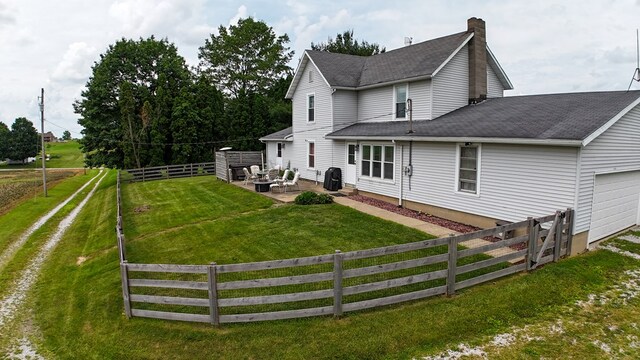 5837 Township Road 103, Mount Gilead, OH 43338 - rear view of house with a chimney, a garage, a fenced backyard, roof with shingles, and driveway