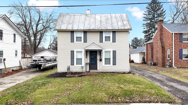 view of front of house featuring cooling unit and a front yard