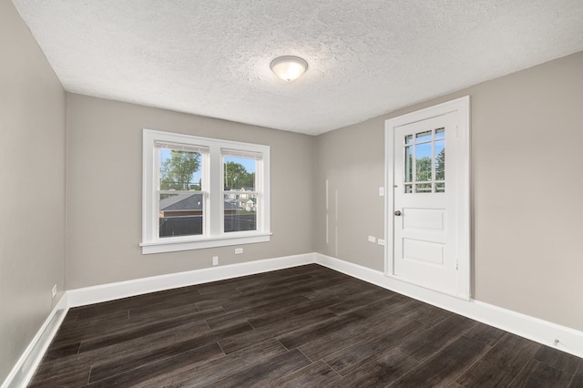 459 Glessner Ave, Mansfield, OH 44903 - spare room with dark wood-style flooring, a textured ceiling, and baseboards