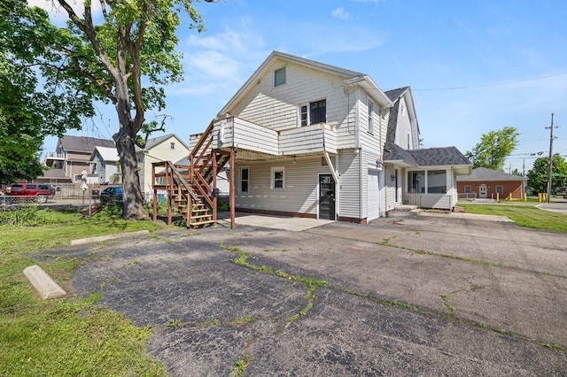 459 Glessner Ave, Mansfield, OH 44903 - back of property featuring asphalt driveway, fence, stairs, and a deck