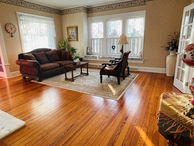 living room featuring wood-type flooring and a healthy amount of sunlight