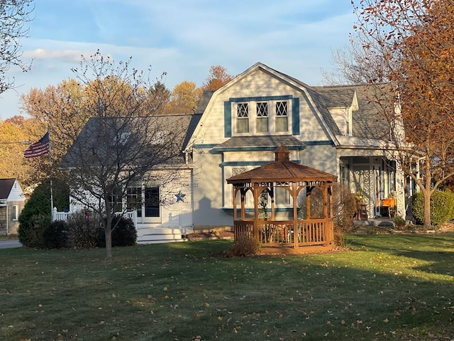 rear view of property with a gazebo and a yard