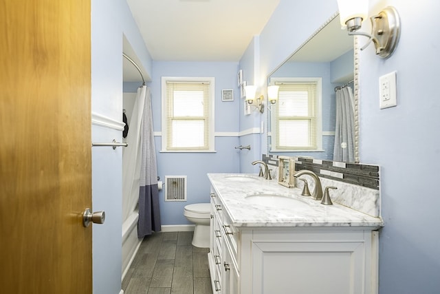 full bathroom featuring vanity, toilet, and shower / bathtub combination with curtain