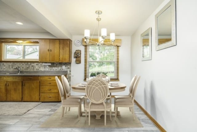 dining room featuring an inviting chandelier and sink