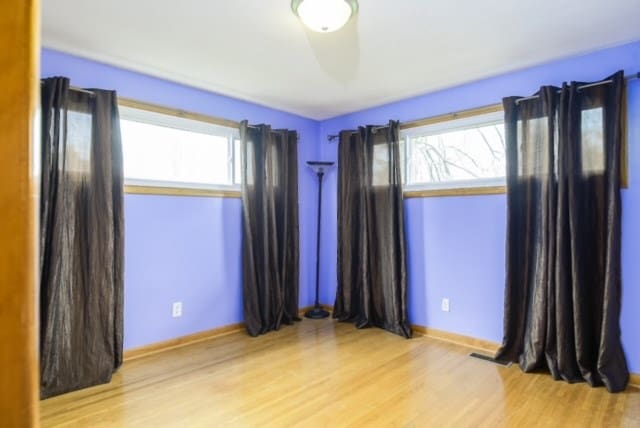 unfurnished room with a healthy amount of sunlight and light wood-type flooring