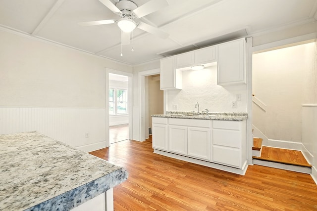 411 Grace St, Mansfield, OH 44902 - kitchen with a sink, white cabinetry, light wood finished floors, ceiling fan, and ornamental molding