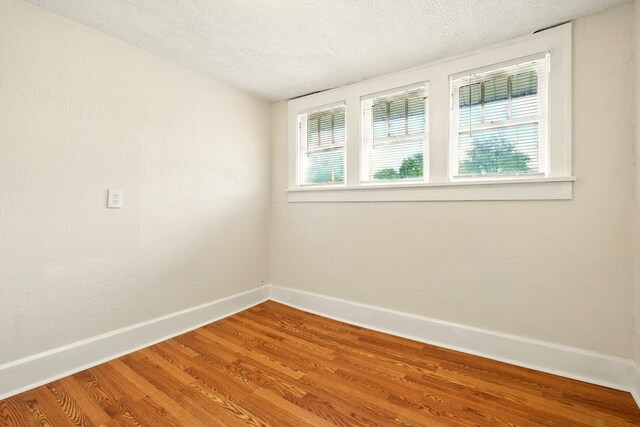 411 Grace St, Mansfield, OH 44902 - unfurnished room featuring baseboards, wood finished floors, and a textured ceiling