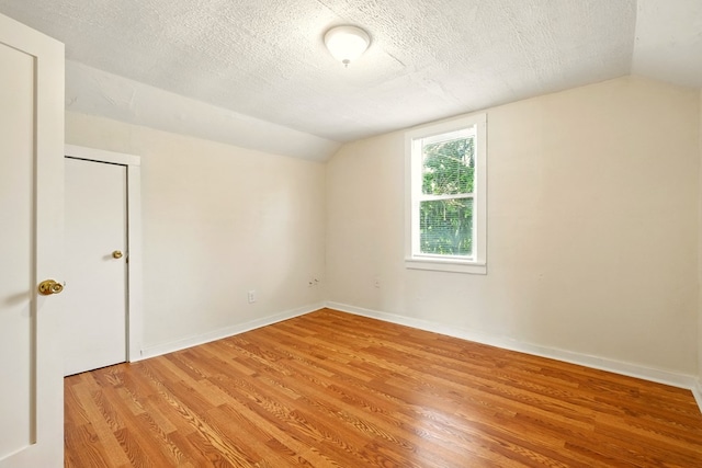 411 Grace St, Mansfield, OH 44902 - additional living space featuring lofted ceiling, light wood finished floors, a textured ceiling, and baseboards