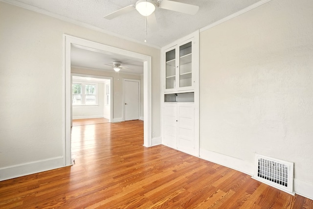 411 Grace St, Mansfield, OH 44902 - empty room with ceiling fan, light wood-type flooring, ornamental molding, baseboards, and built in shelves